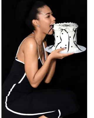 21st birthday portrait, dark studio backdrop with a cake
