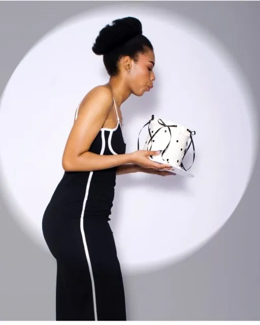 Studio portrait in a black dress, spotlight backdrop